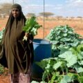 Habiba displays some of the spinach and kale from her farm on September 11, 2025. The leafy vegetables are among the diverse crops she grows.